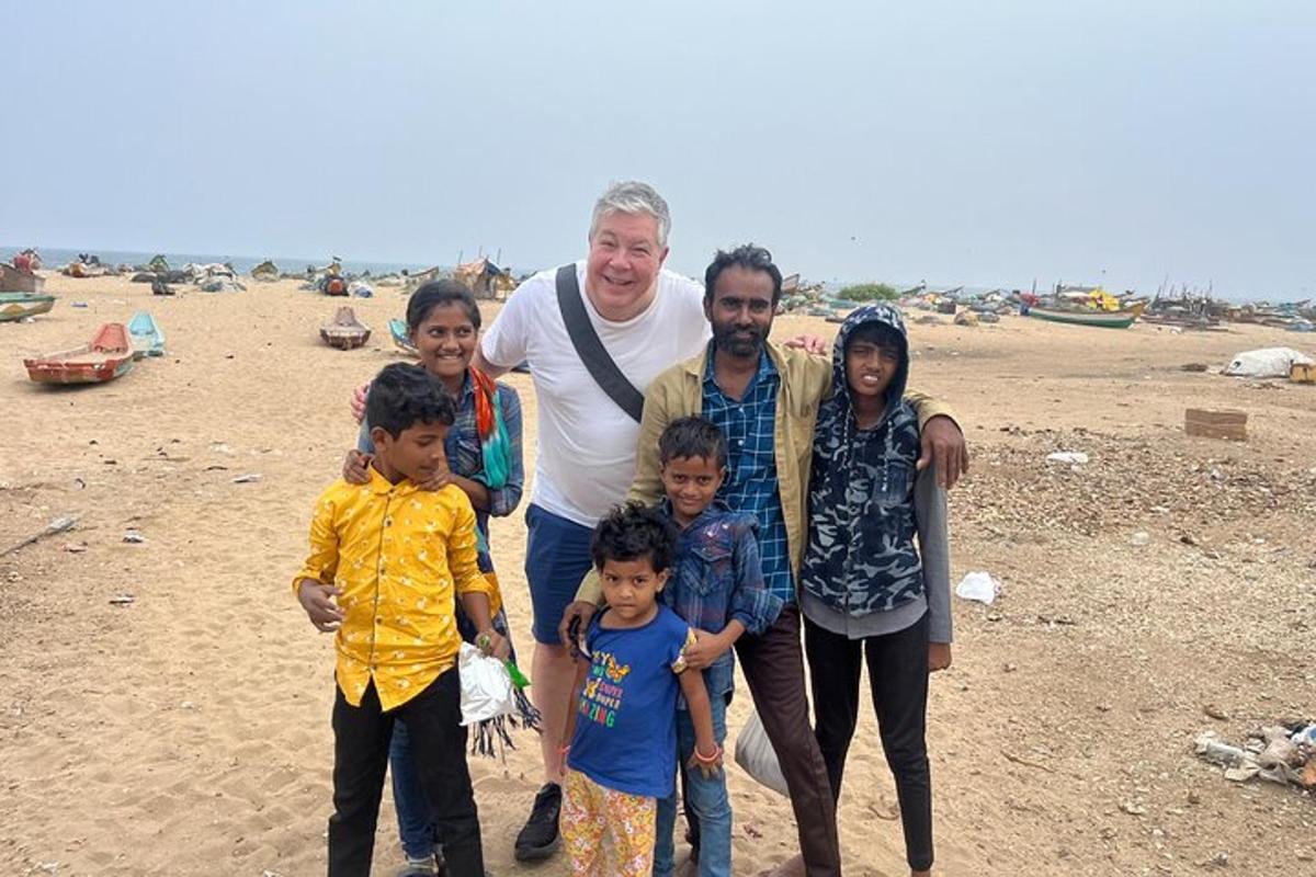 a man and his family standing on the beach