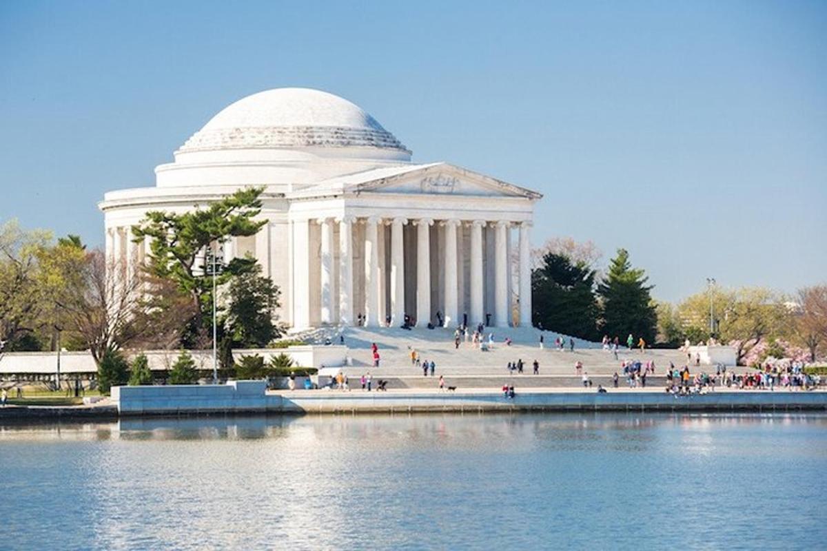 a large building with a dome in front of a body of water