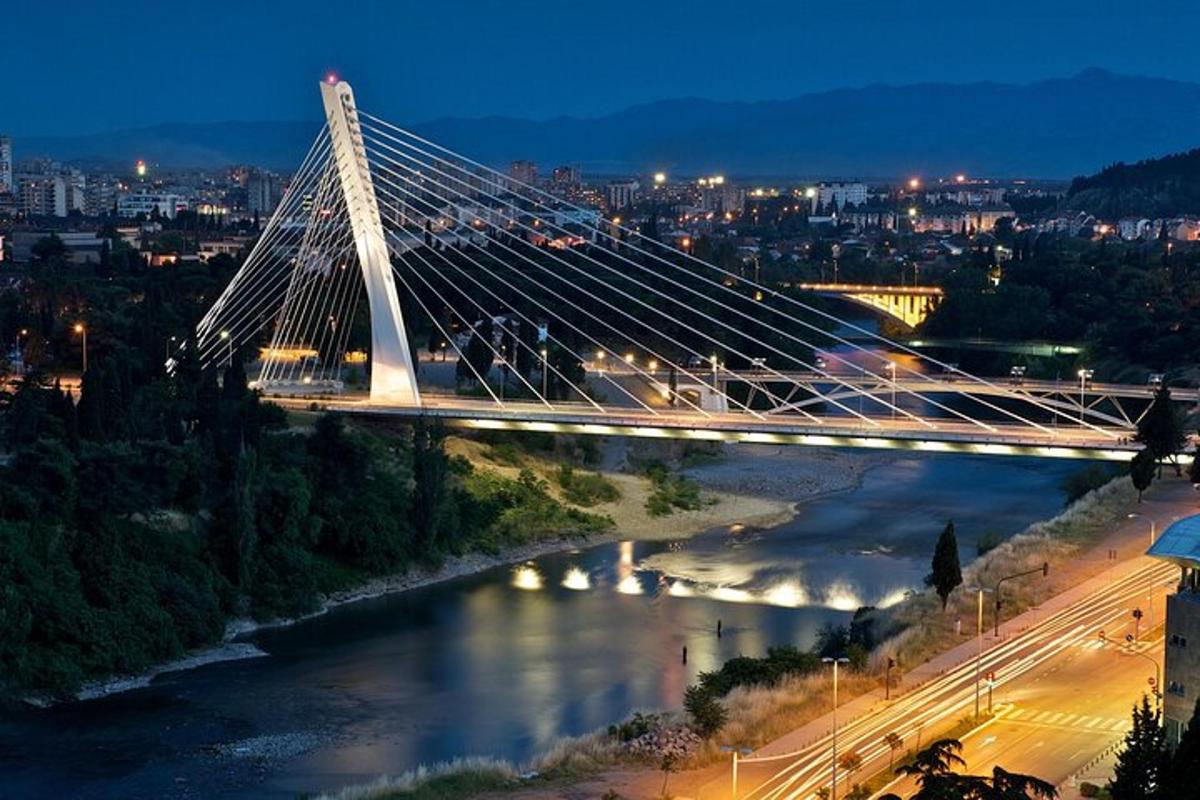 a lit up bridge over a river at night