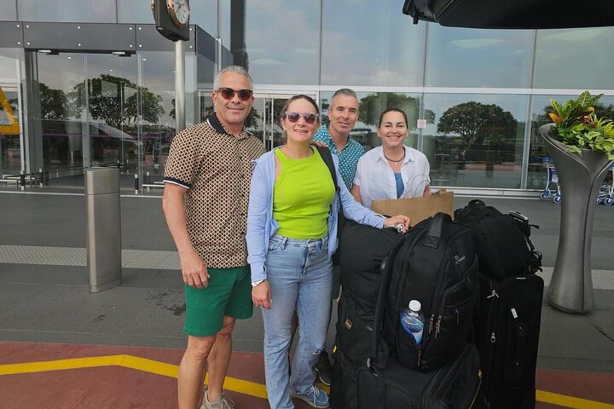 a group of people posing for a picture with luggage