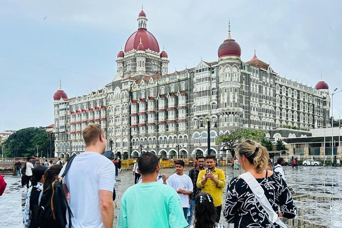 a group of people standing in front of a large building