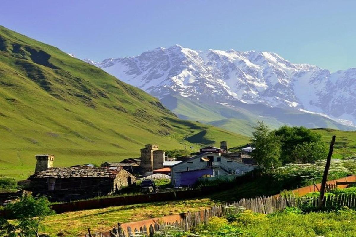 a village on a hill with a mountain in the background