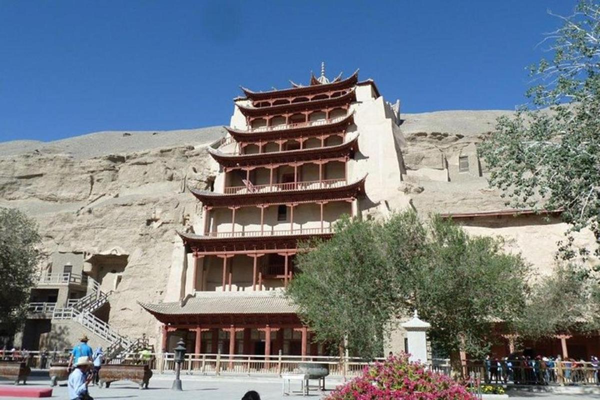 a large building with a mountain in the background