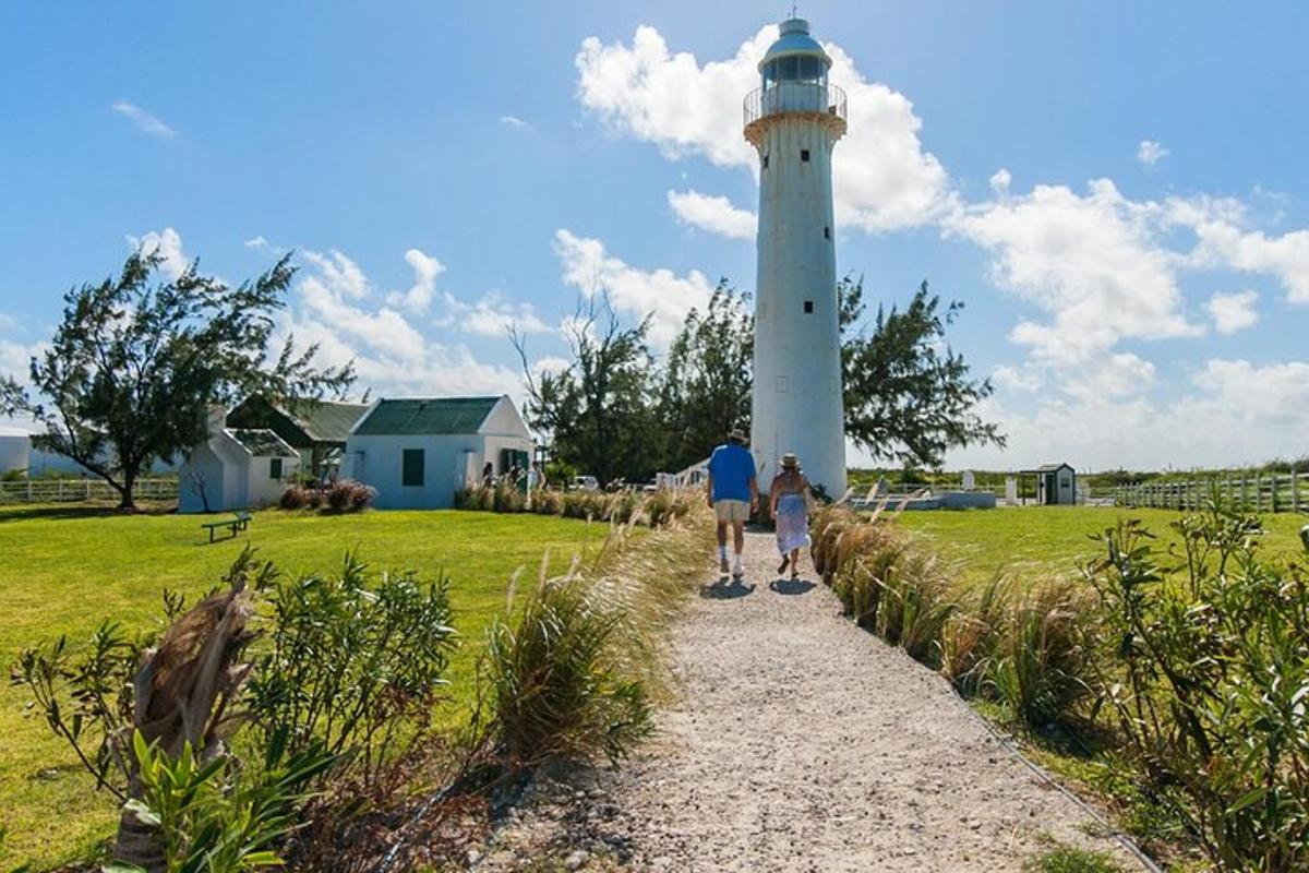 a man and a child walking towards a lighthouse