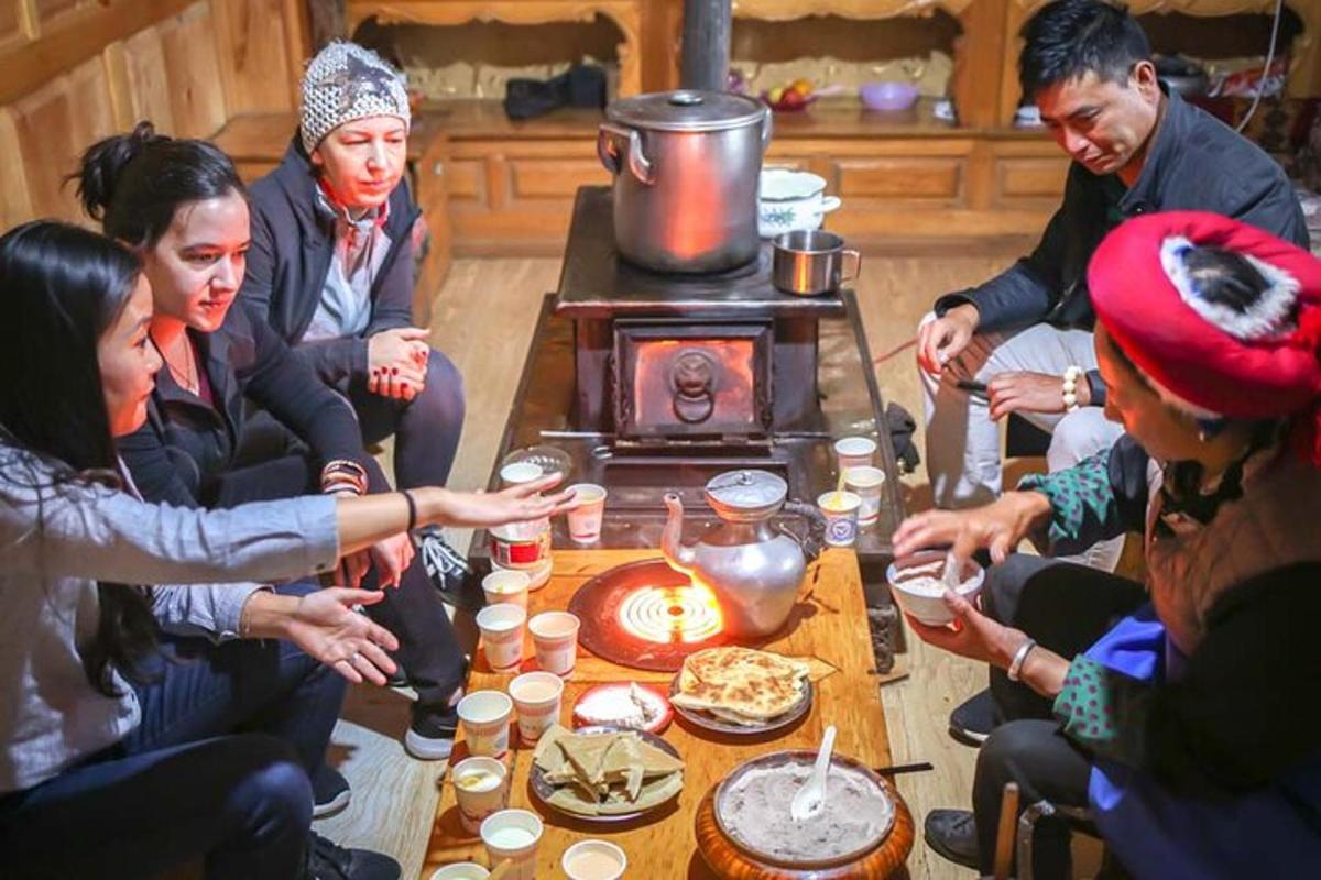 a group of people sitting around a table with food