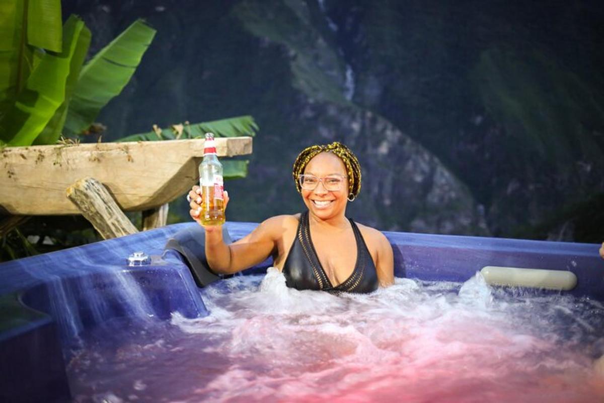 a woman in a bathtub holding a bottle of beer