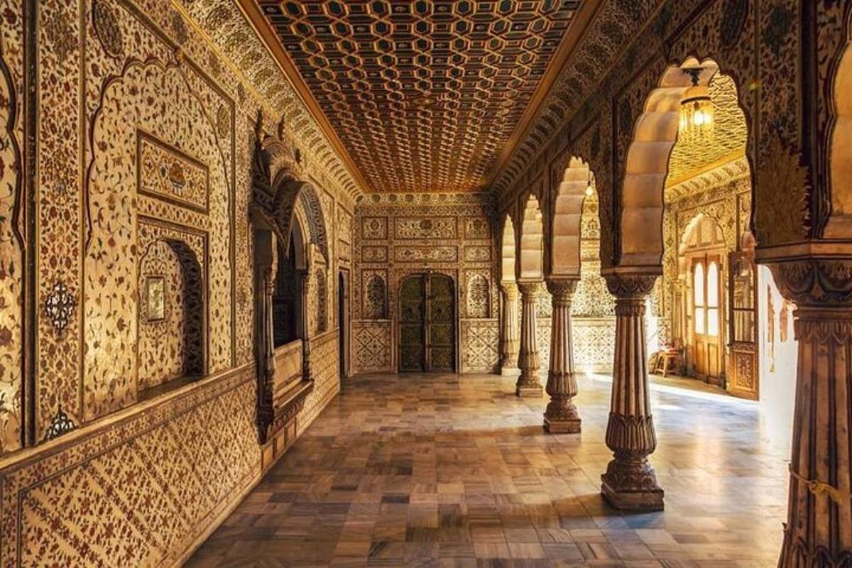 a large room with a hallway with ornate walls