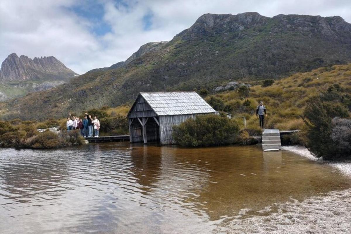 a group of people standing on a bridge over a body of water