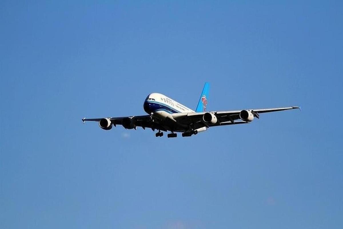 an airplane is flying in the blue sky