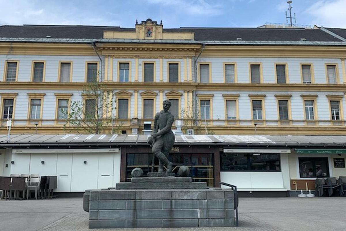 a statue of a man in front of a building