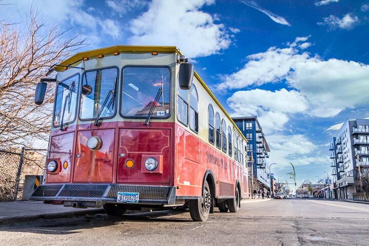 an old red and yellow bus parked on a street