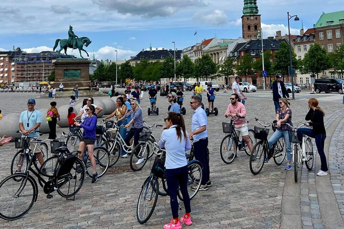 a group of people standing around on bikes in a city