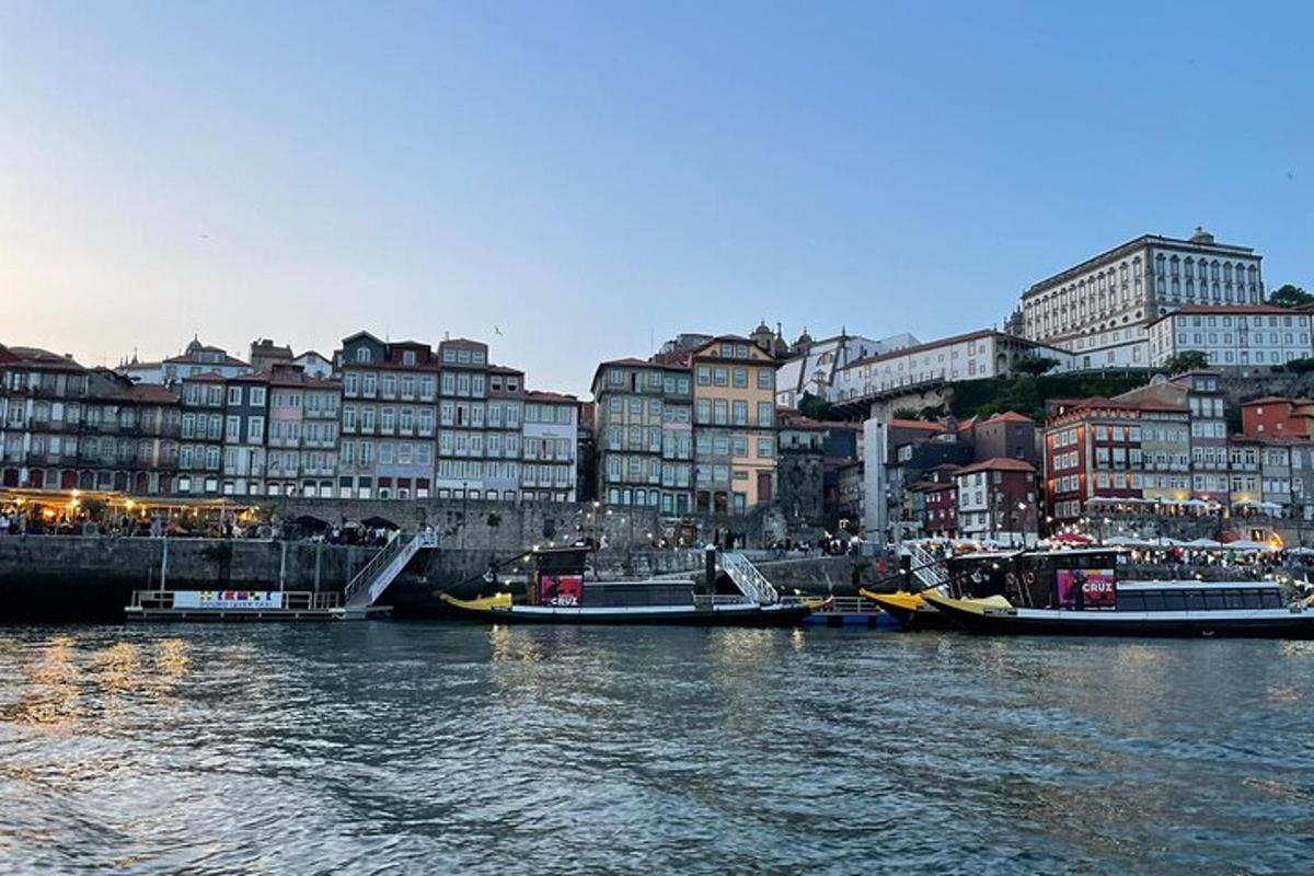 a group of boats docked in a river with buildings
