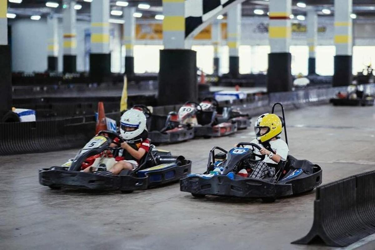 a group of people riding in toy cars on a track
