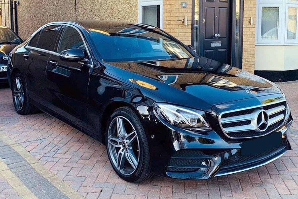 a black car parked on a brick street