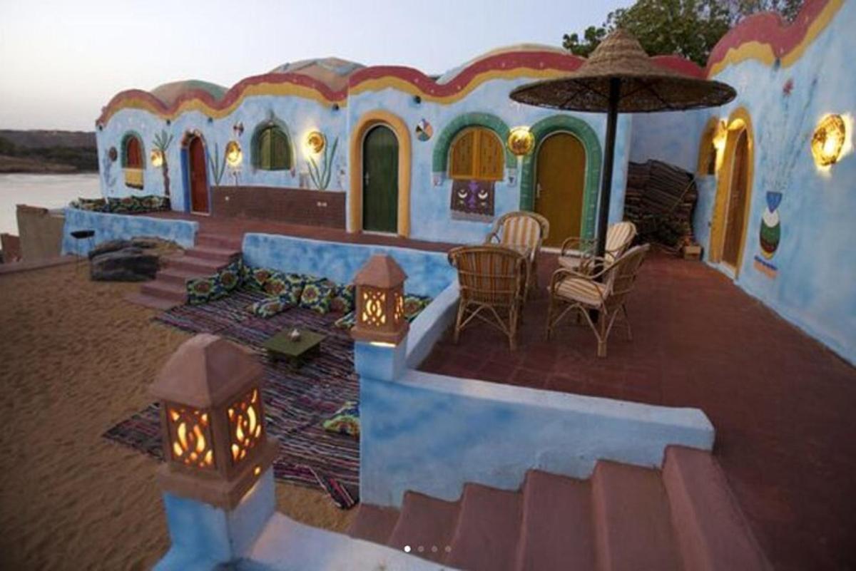 a house with a patio with a table and an umbrella