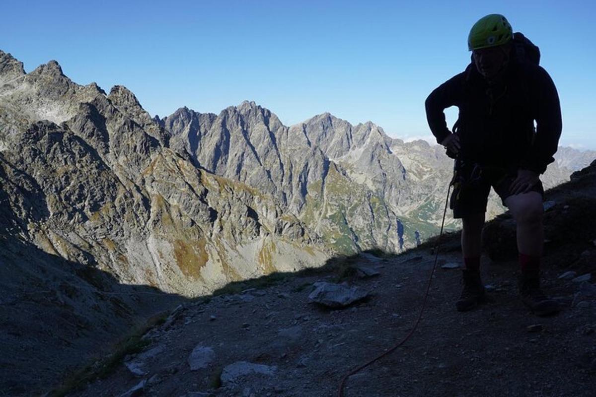 a person standing on the side of a mountain