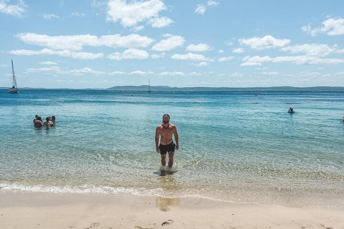 um homem parado na água na praia