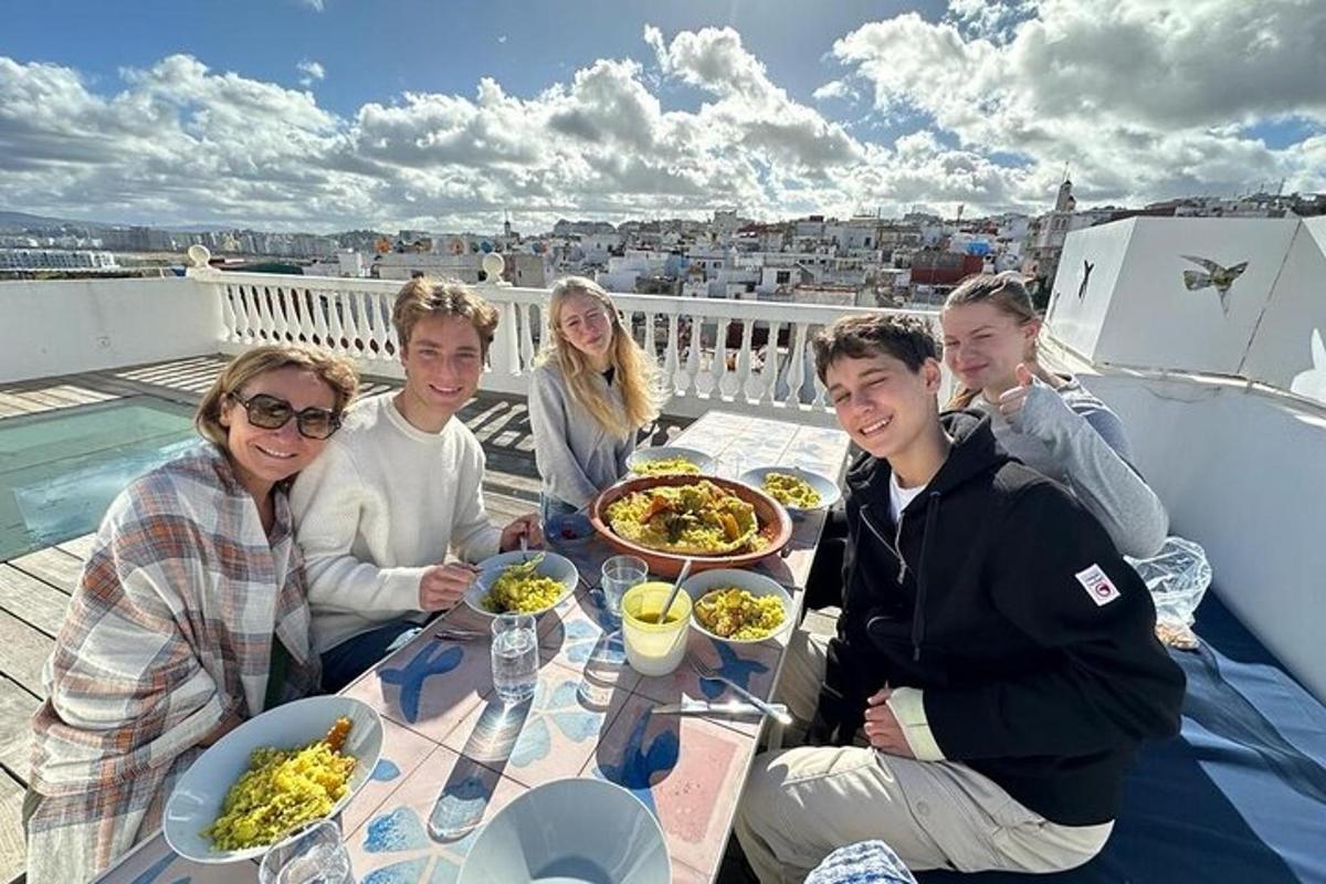 a group of people sitting around a table with food