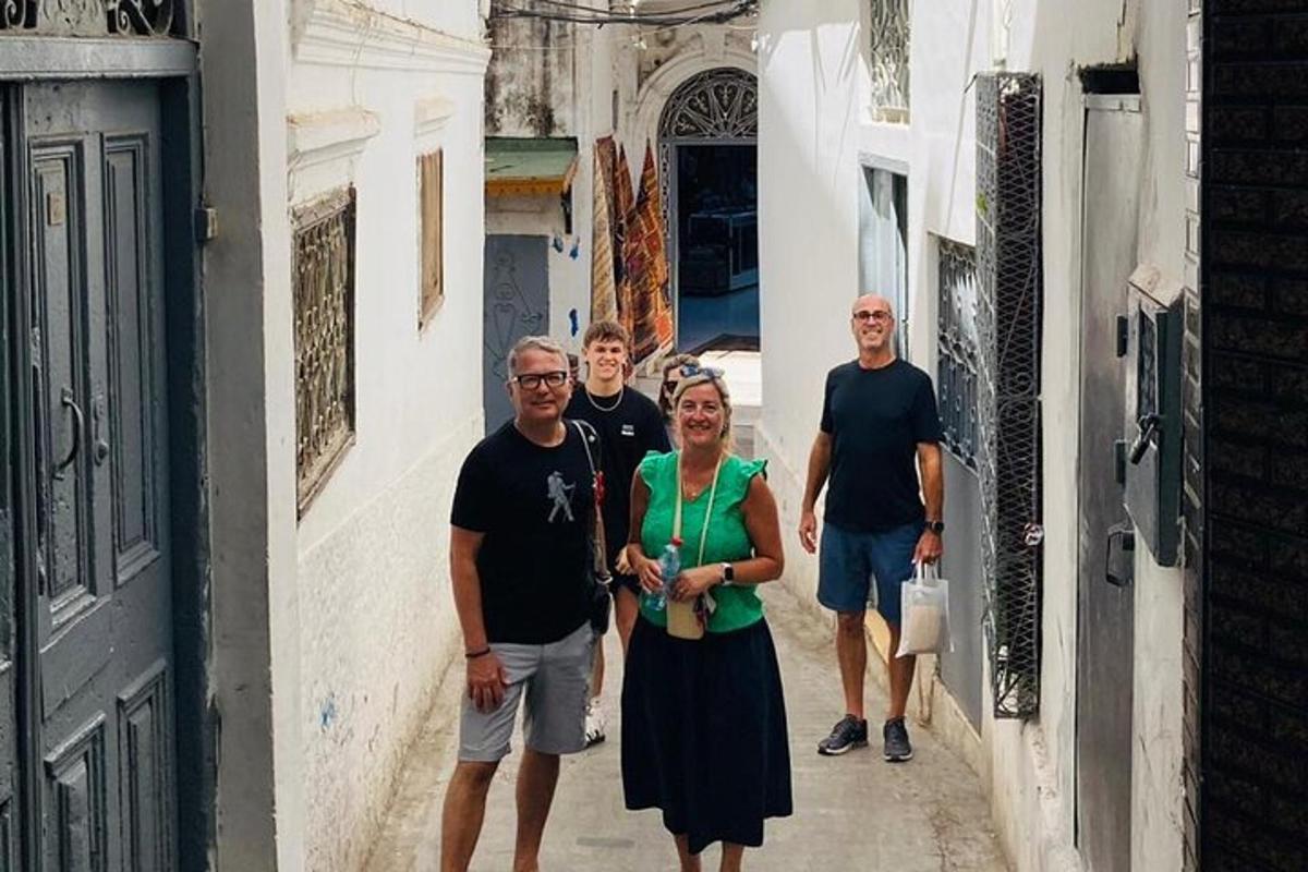 a group of people walking down a narrow alley