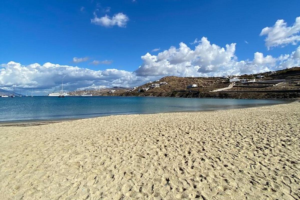 plaža s peskom, vodo in oblaki