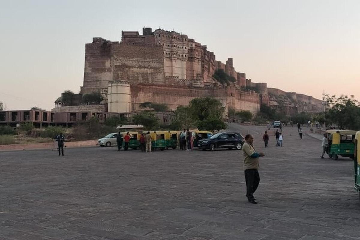 a person standing in a parking lot in front of a castle