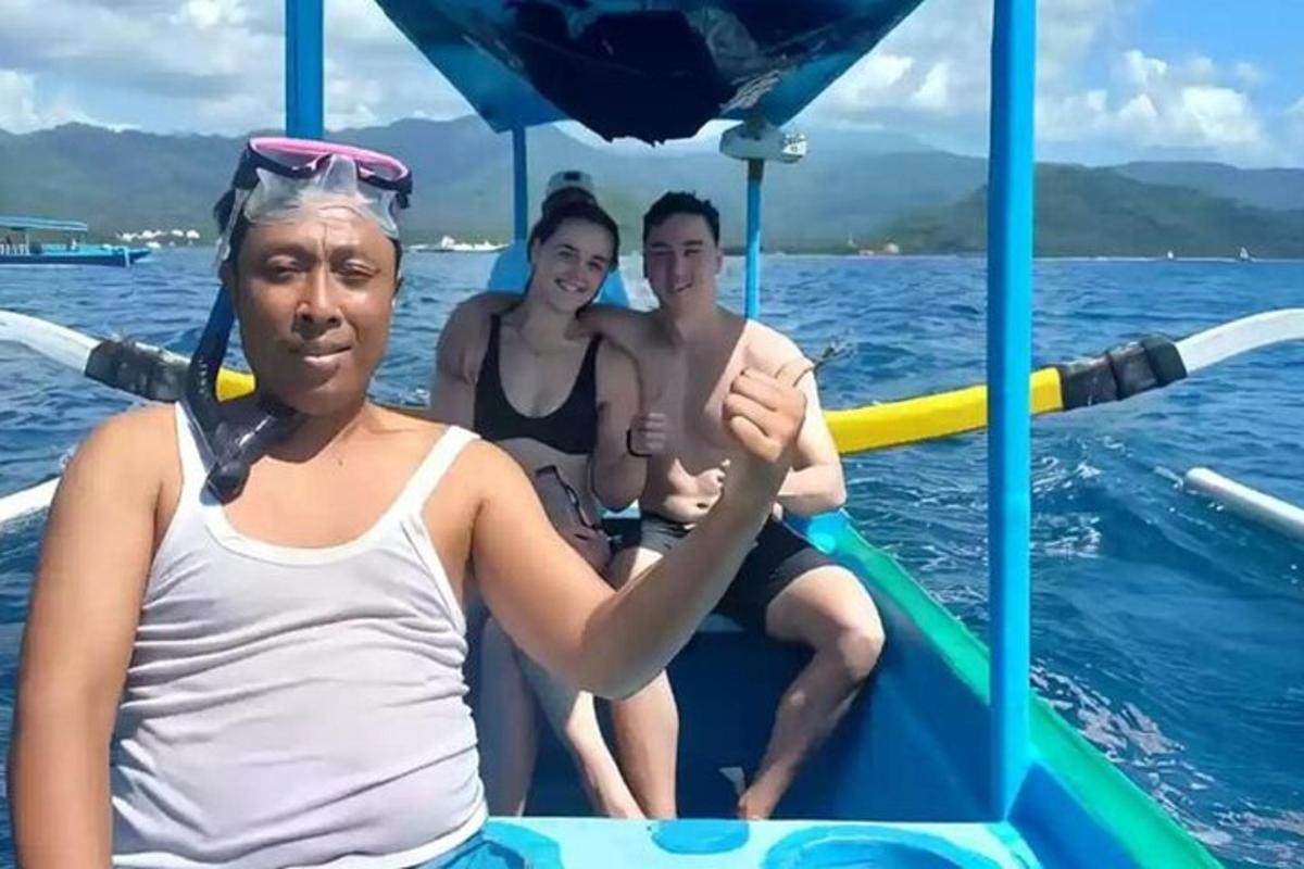 a group of people on a boat in the water