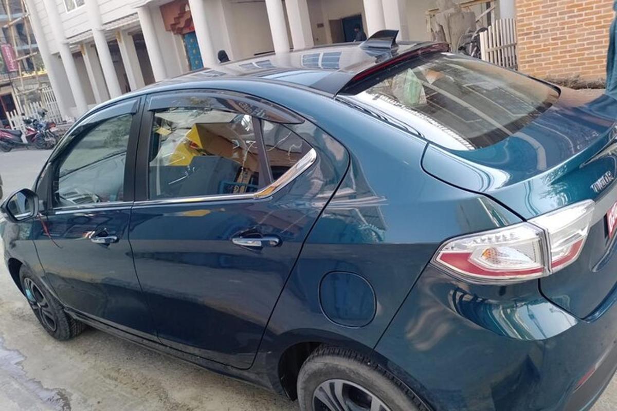 a small blue car parked in a parking lot