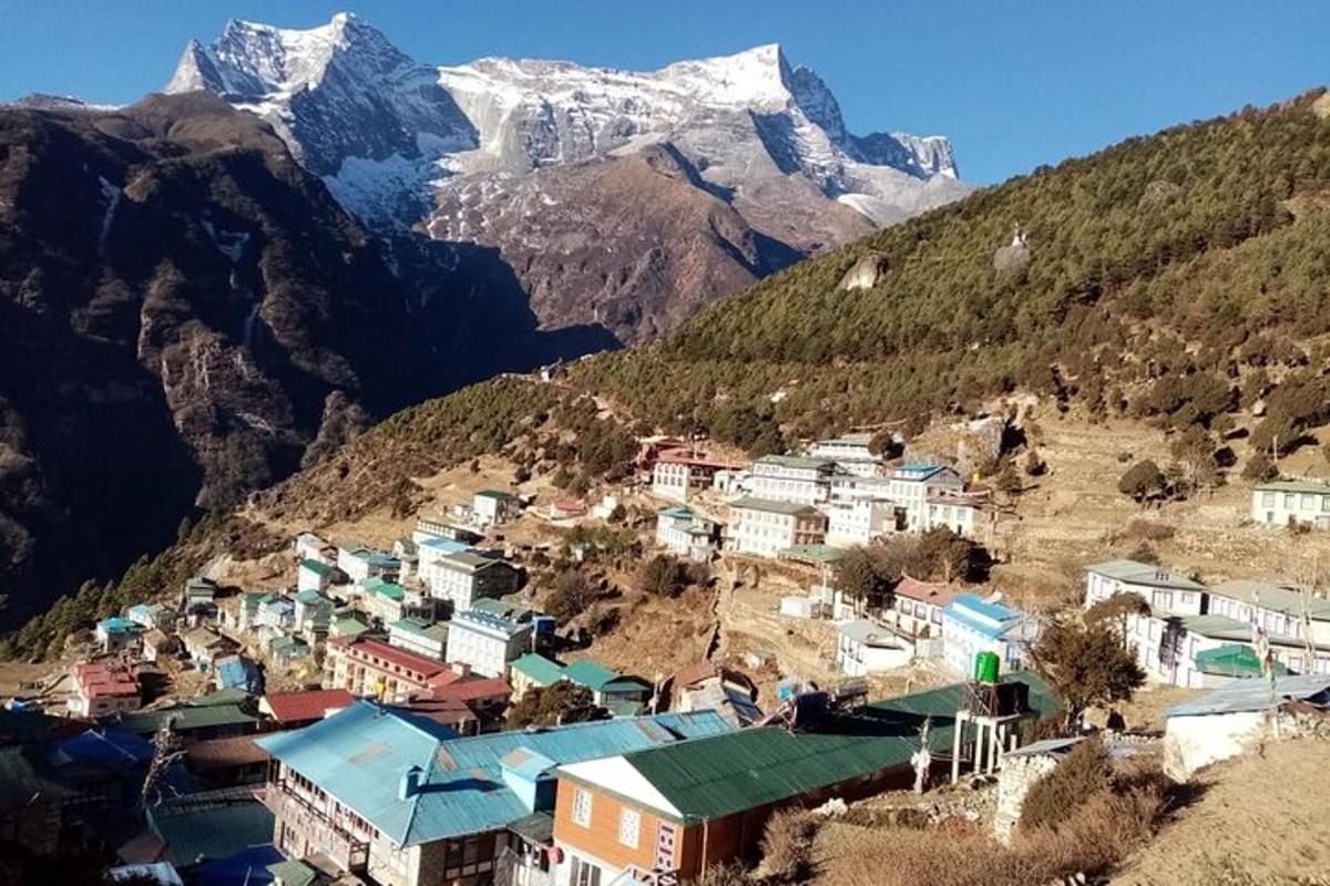 a village in the mountains with a snow covered mountain