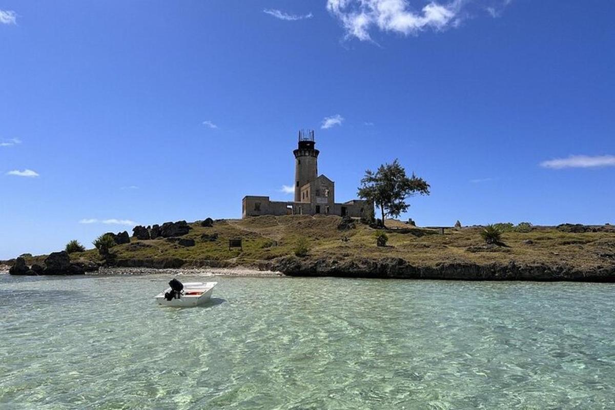 a person in a boat in the water with a lighthouse