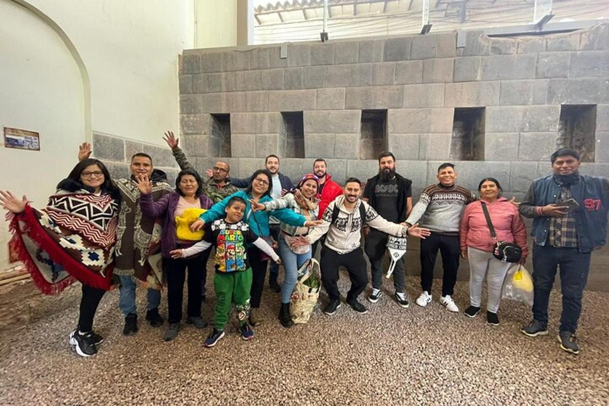 un grup de persones posant per a una foto davant d'una paret