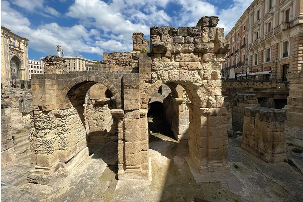 an old stone bridge in a city with buildings