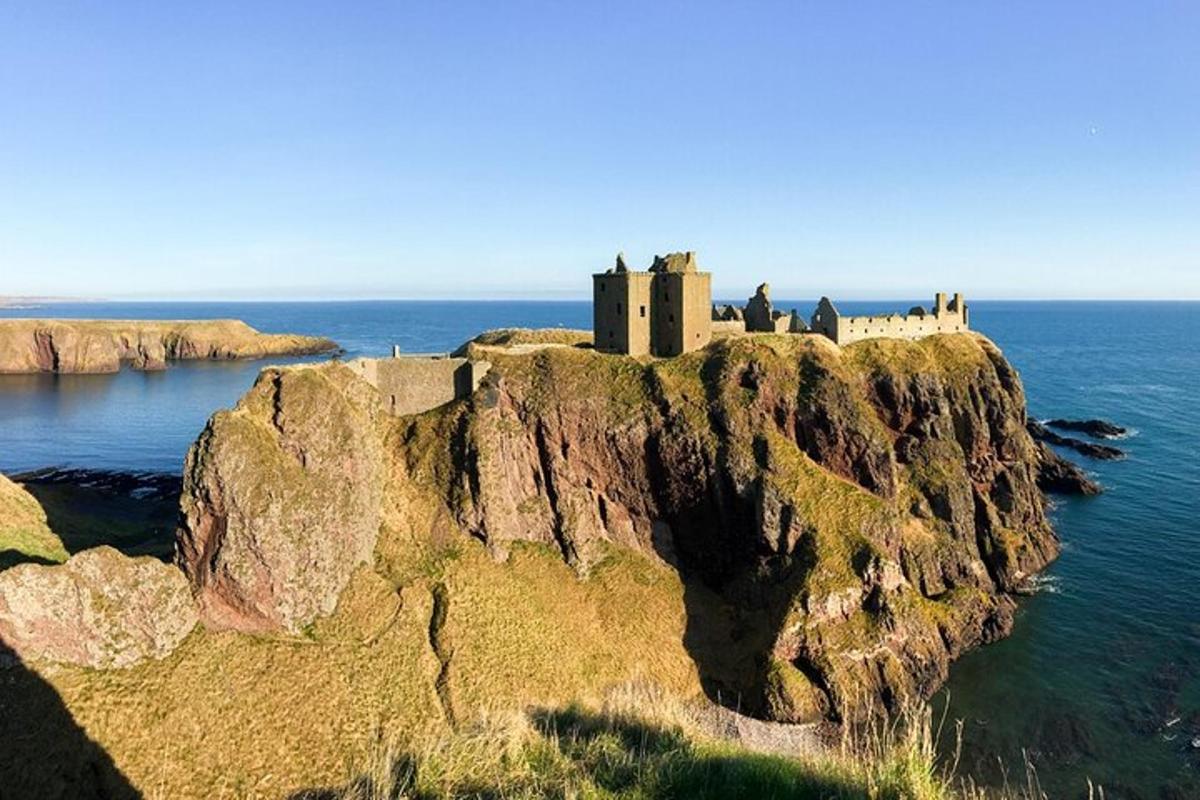 a castle on a rocky island in the ocean