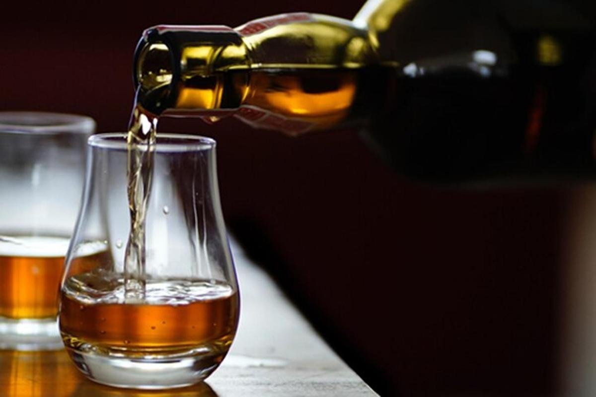 a drink being poured into a glass