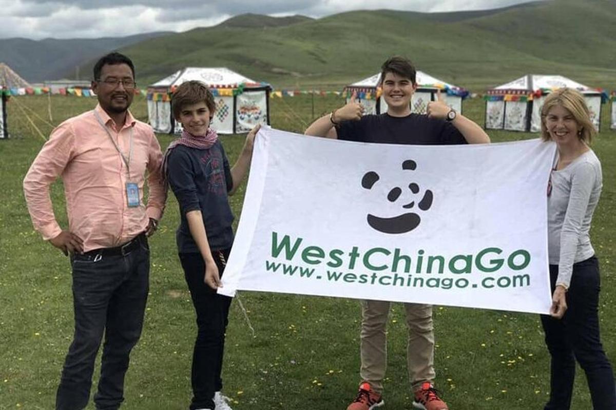 a group of people holding a sign in a field