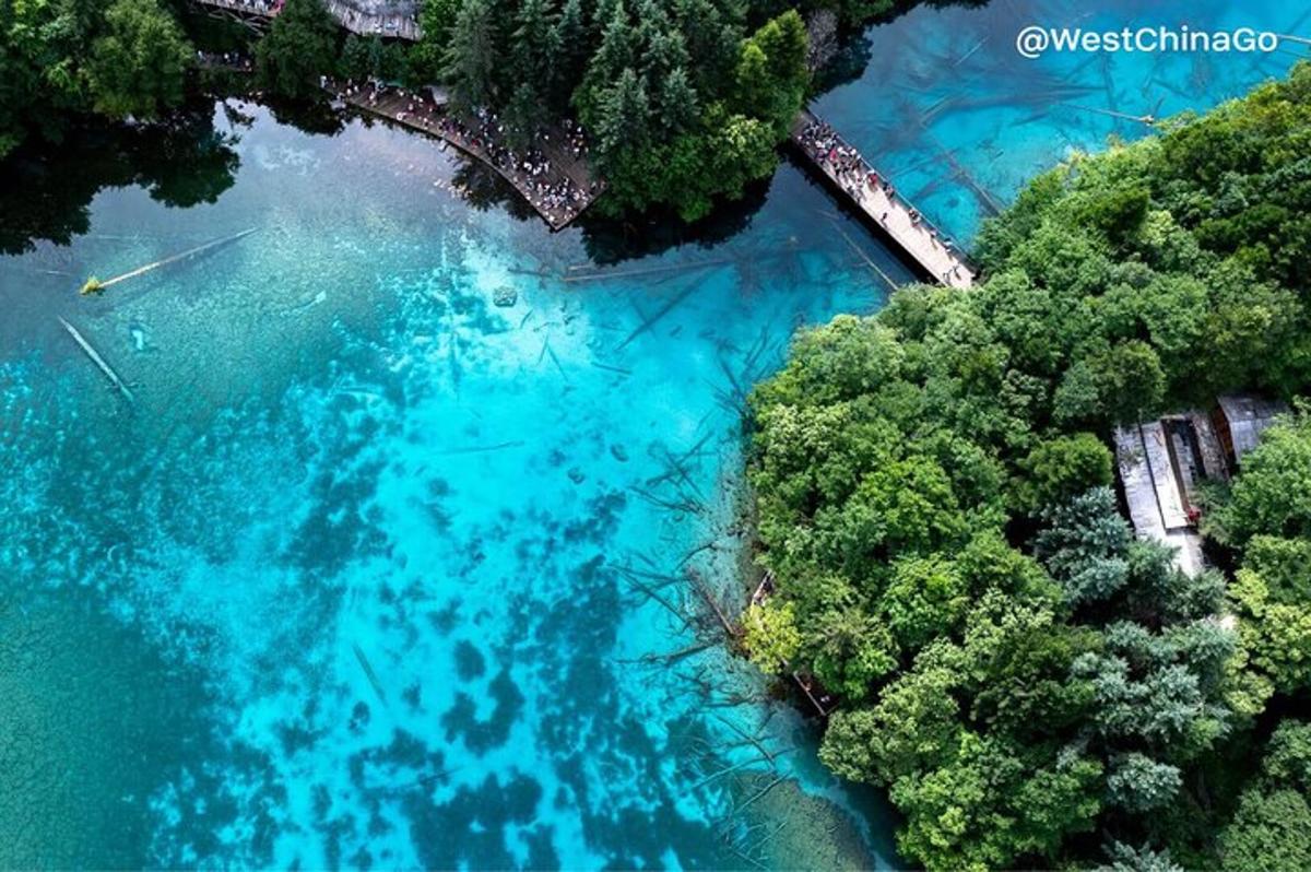 an aerial view of a river with blue water