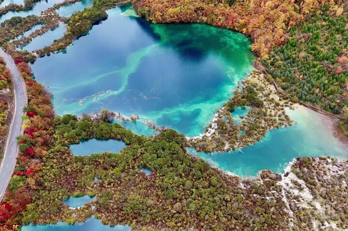 an aerial view of a river with turquoise water