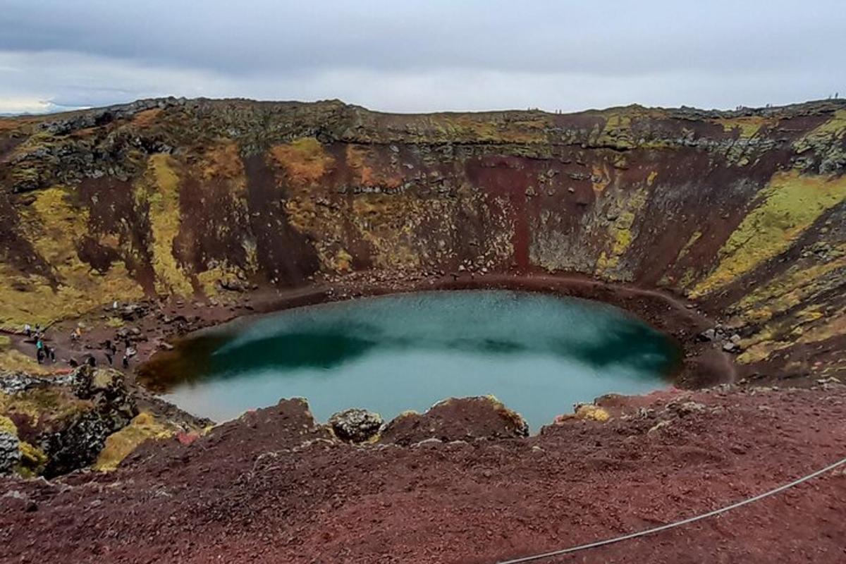 a pool of water in the middle of a cliff