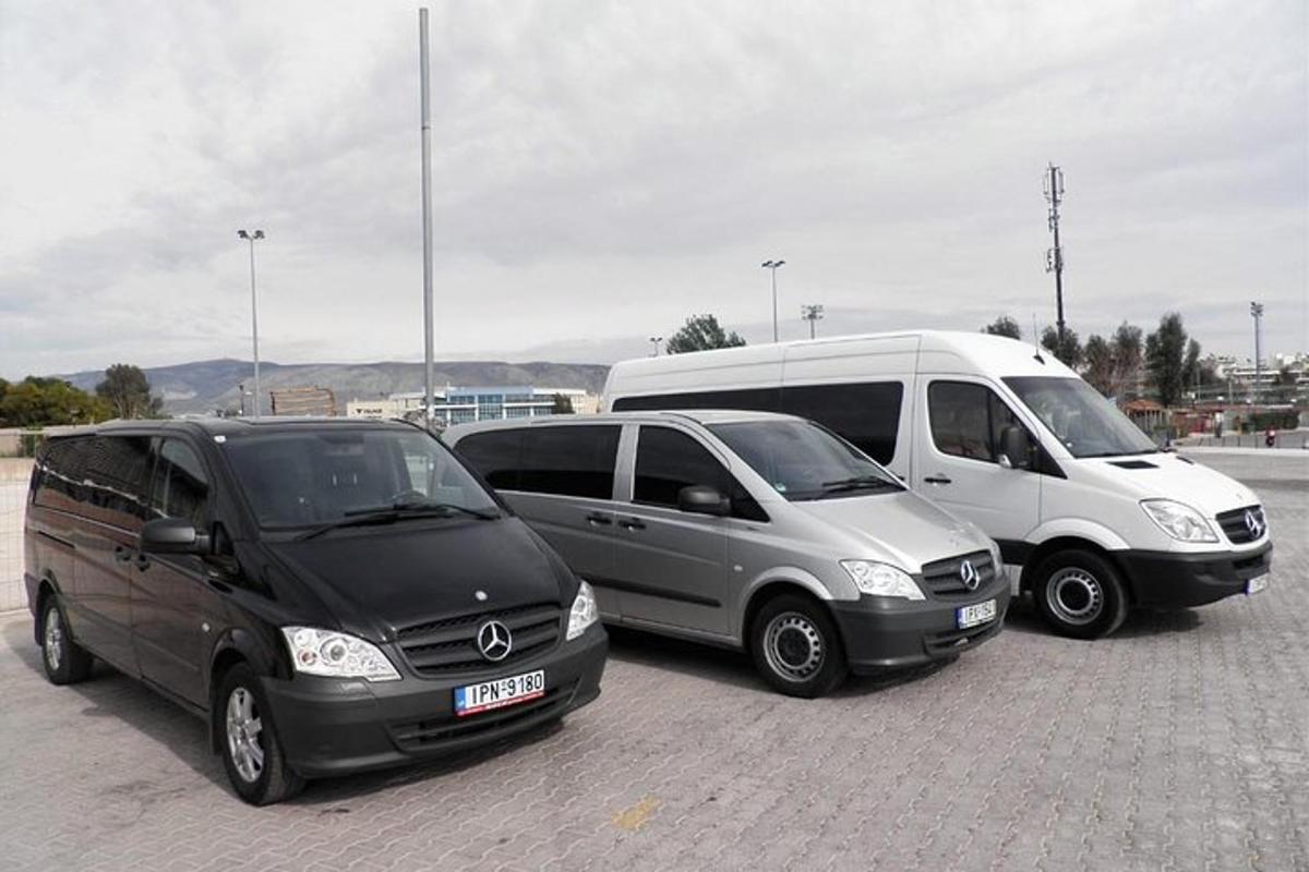 three vans parked next to each other in a parking lot