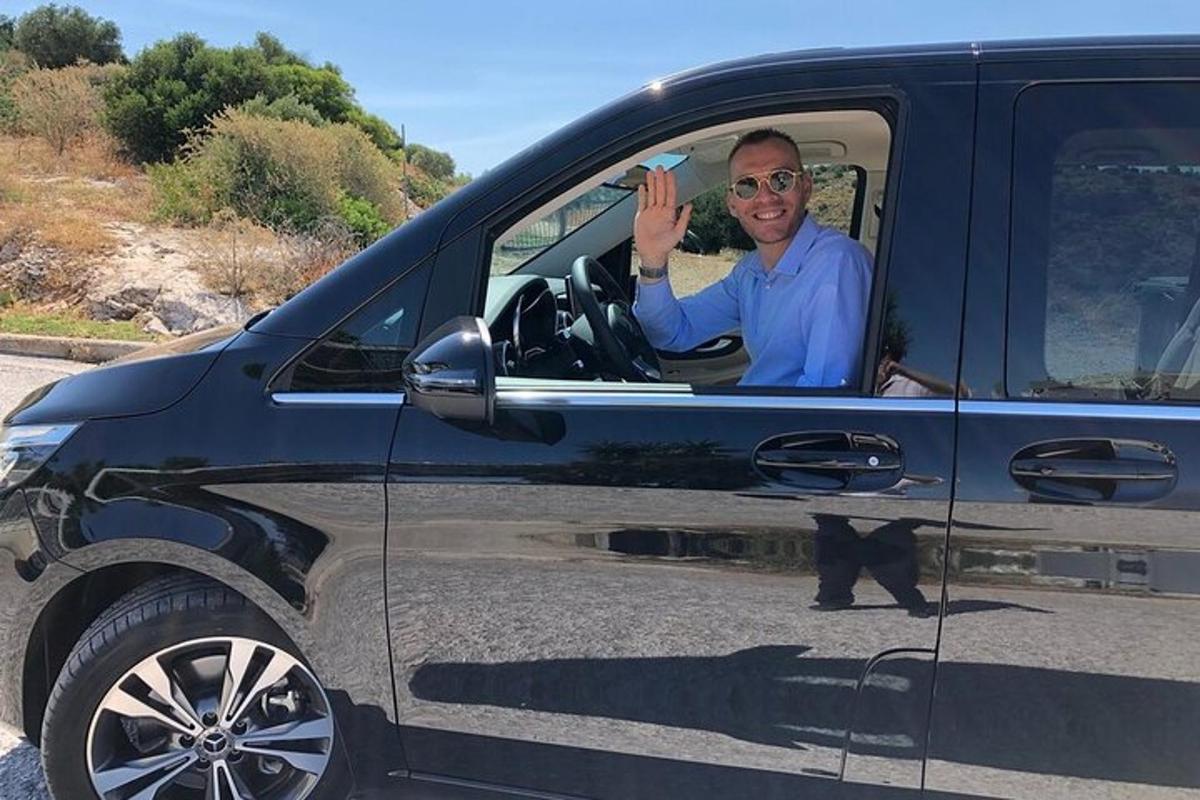 a man sitting in the drivers seat of a car