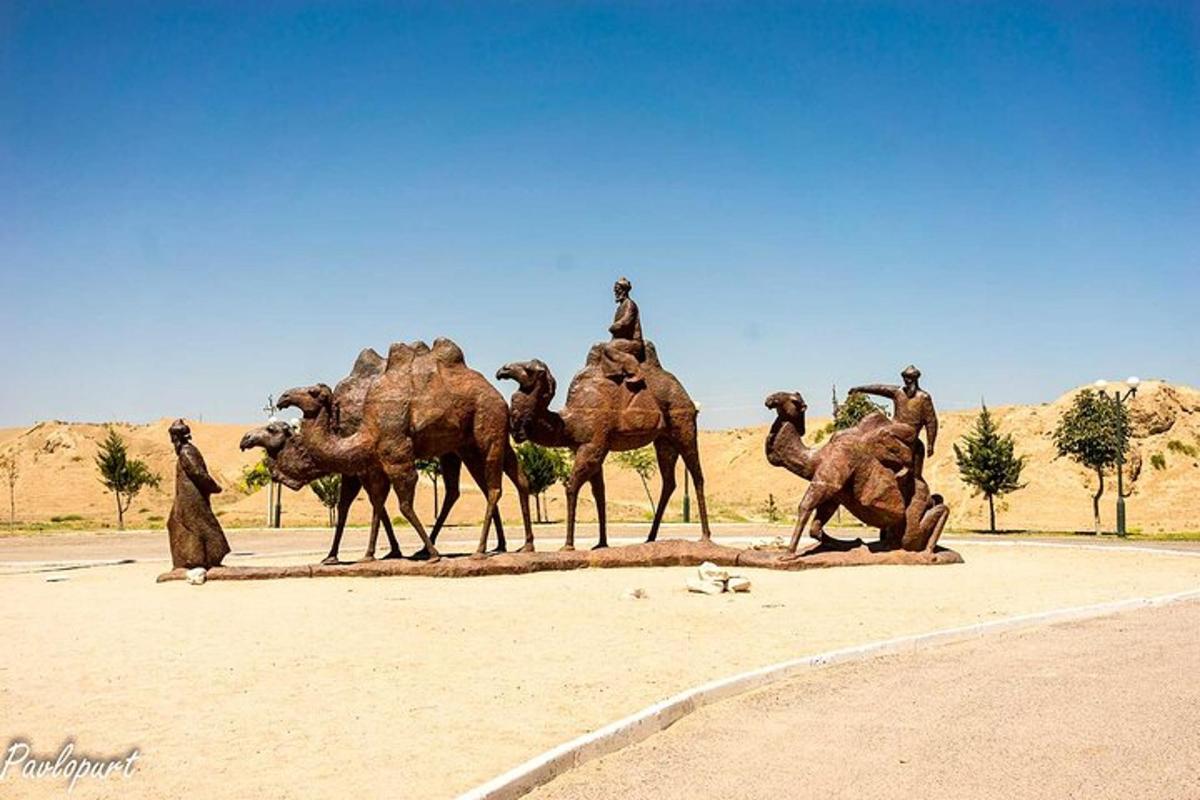 a group of camel statues in the desert