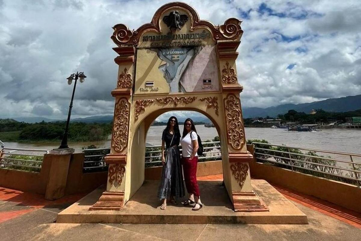 two women standing in an archway on a bridge