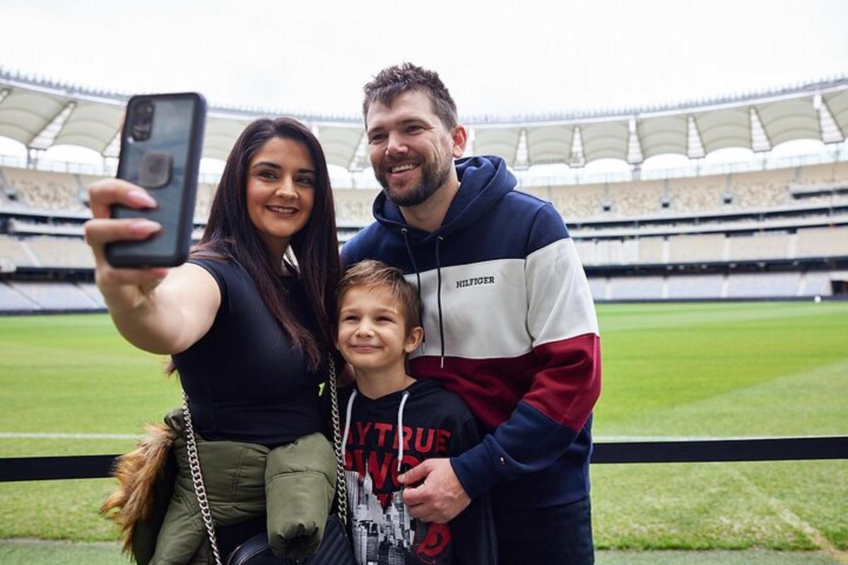 a man and a woman taking a picture at a stadium