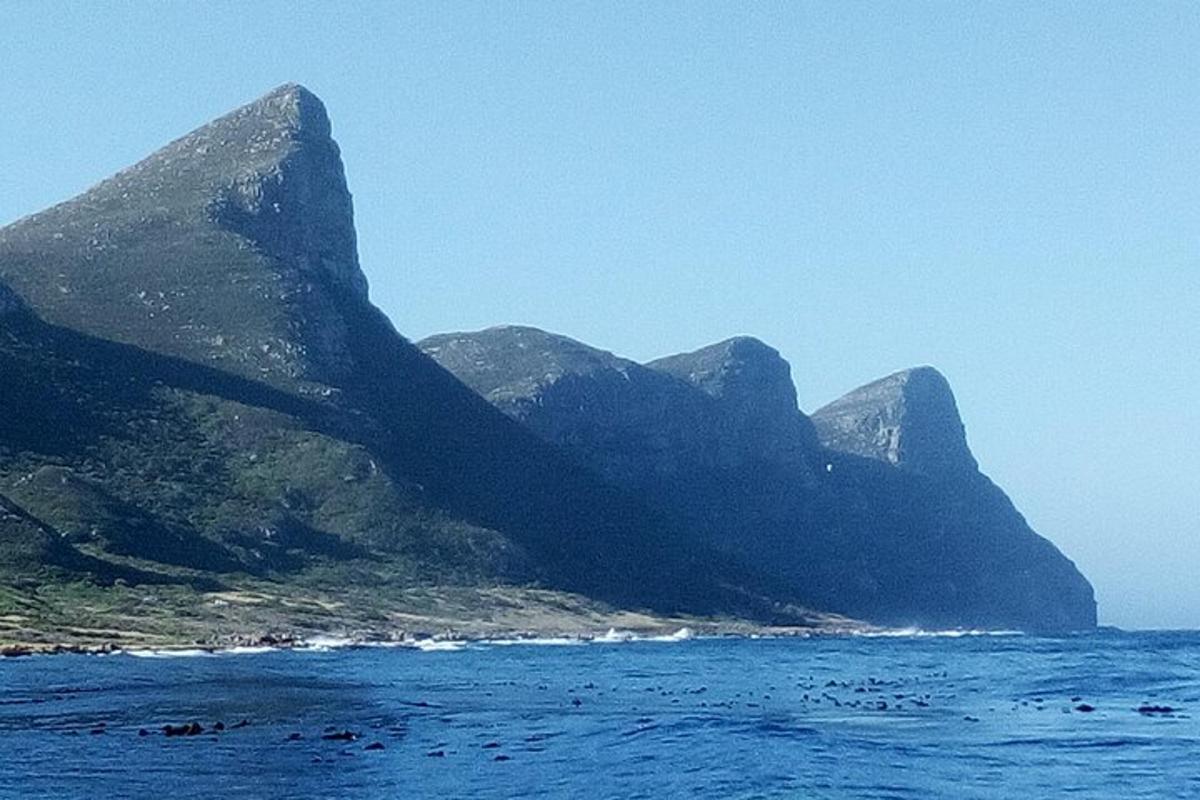 a group of mountains in the ocean on a clear day