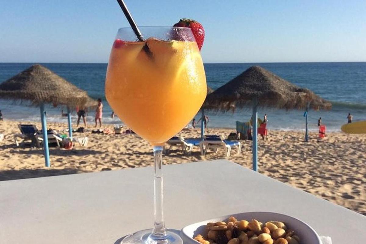 a drink sitting on a table at the beach