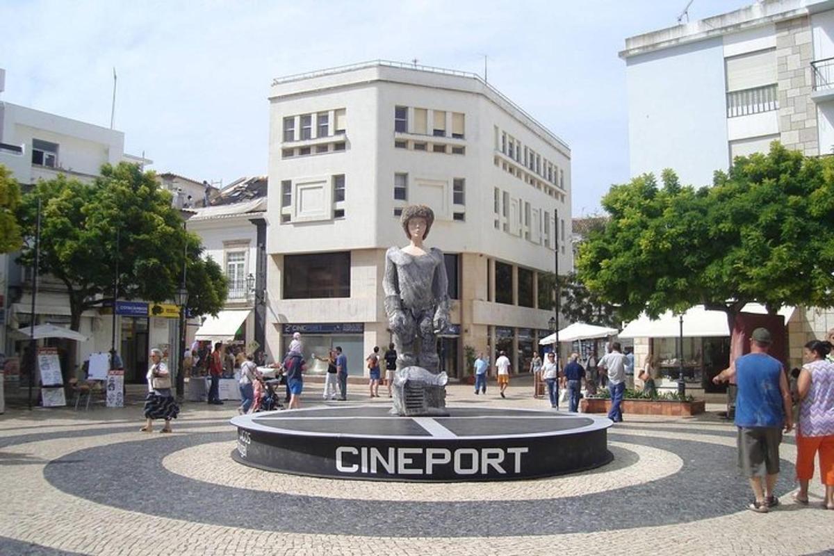 a statue of a man on a skateboard in a city