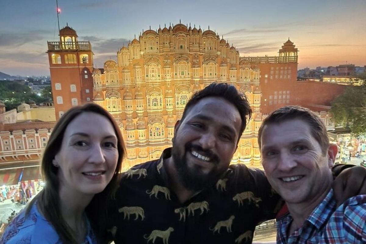 a man and a woman posing in front of a building