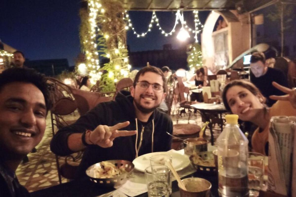 a group of people sitting at a table eating food