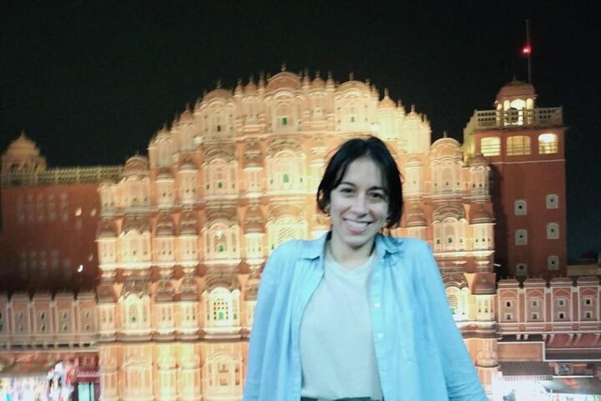 a woman standing in front of a large building