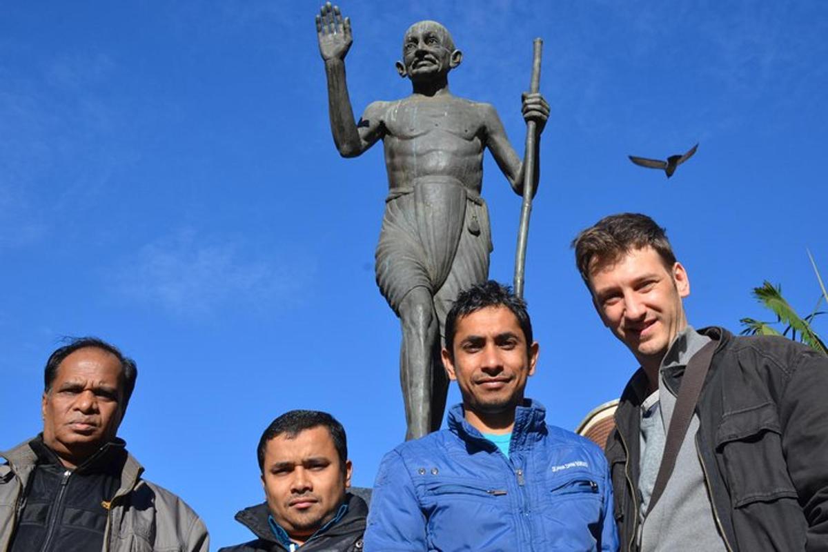 a group of men standing in front of a statue